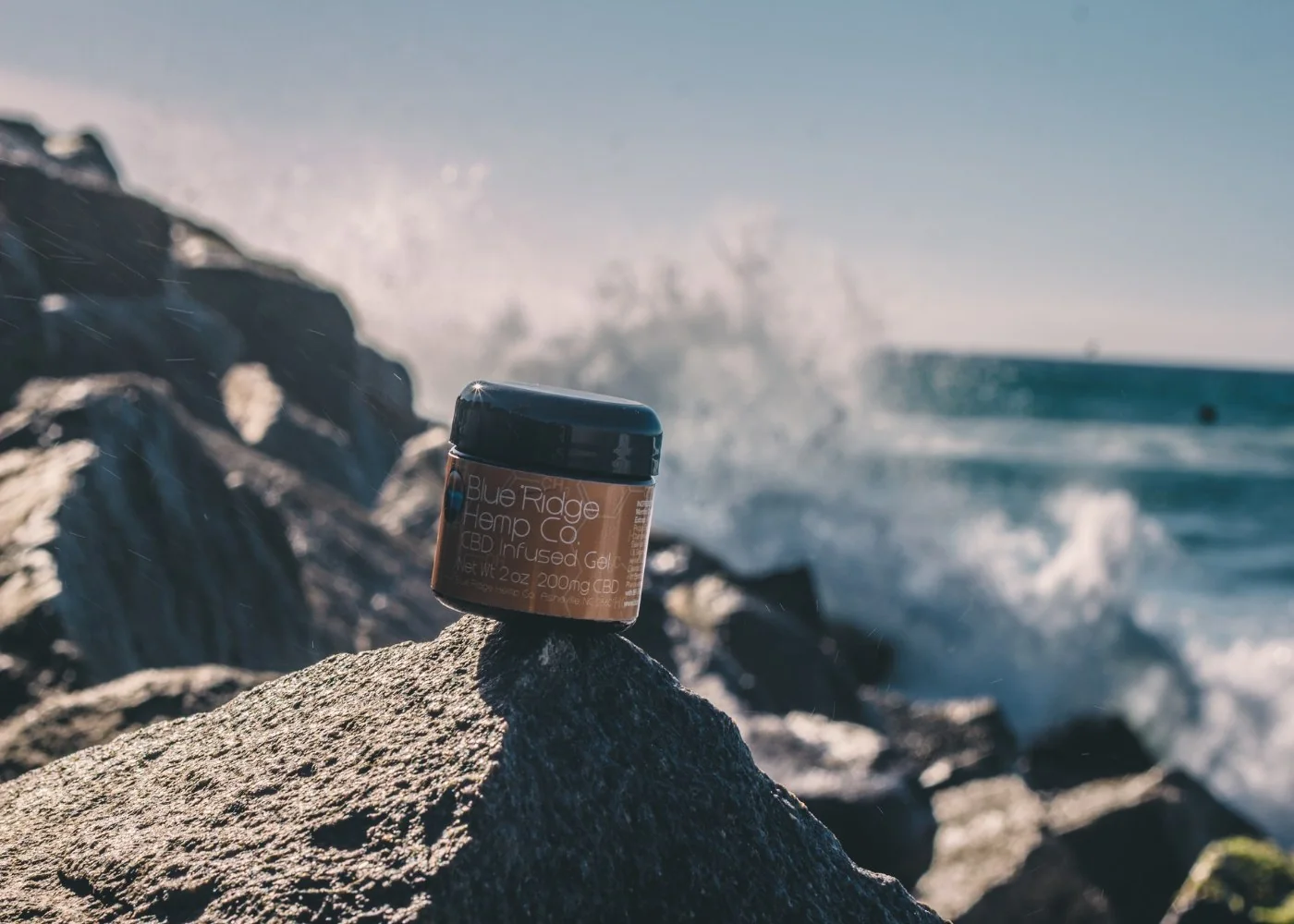 Product shot of a jar on coastal rocks